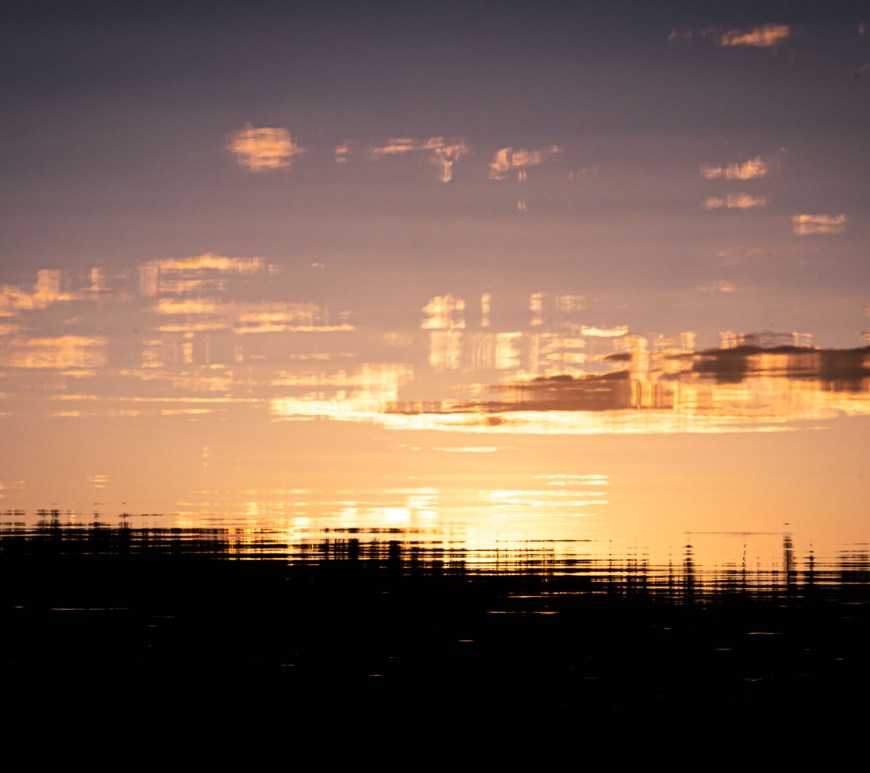 Sunset reflected on lightly rippling waters