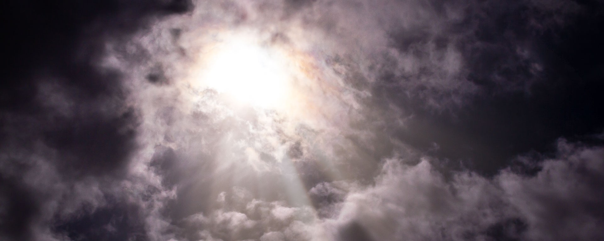 Sun light beams through thick clouds.