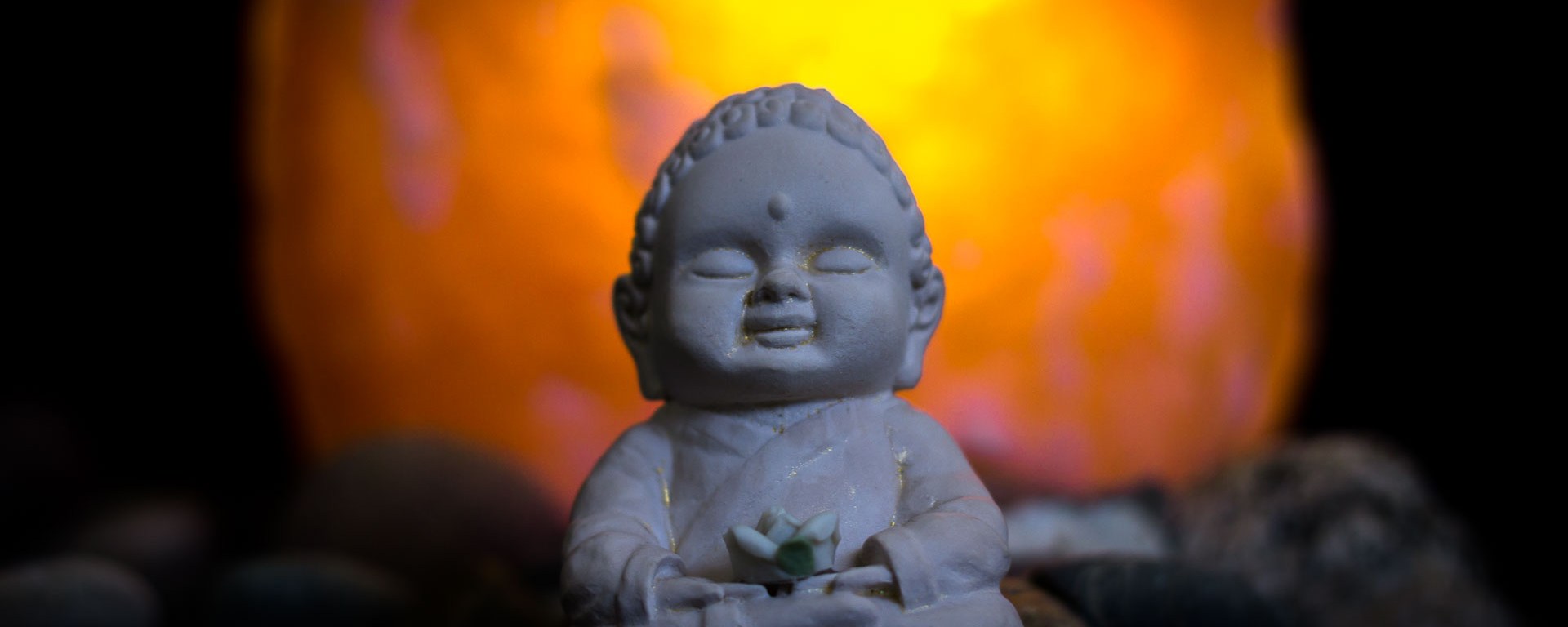 Buddha sits in front of a great light