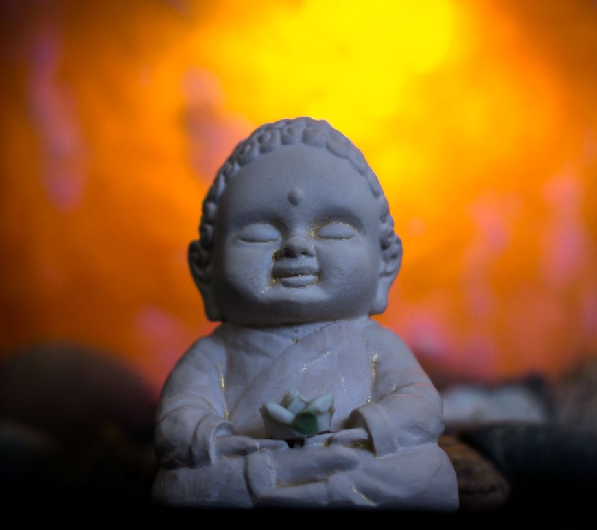 Buddha sits in front of a great light