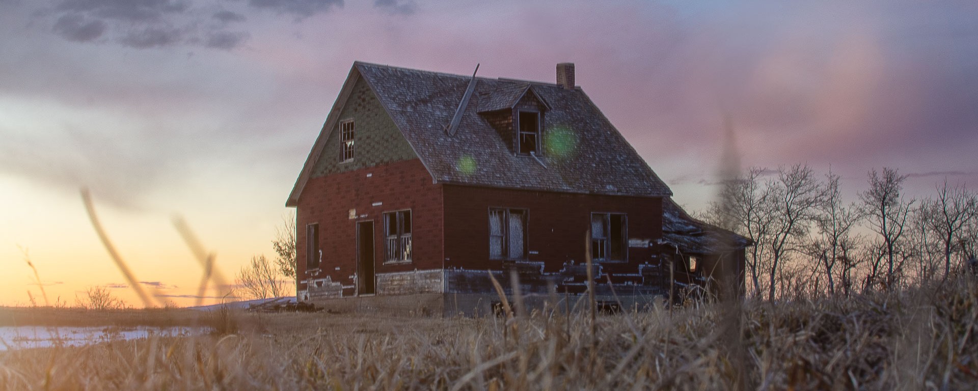 An abandoned house at sunset.
