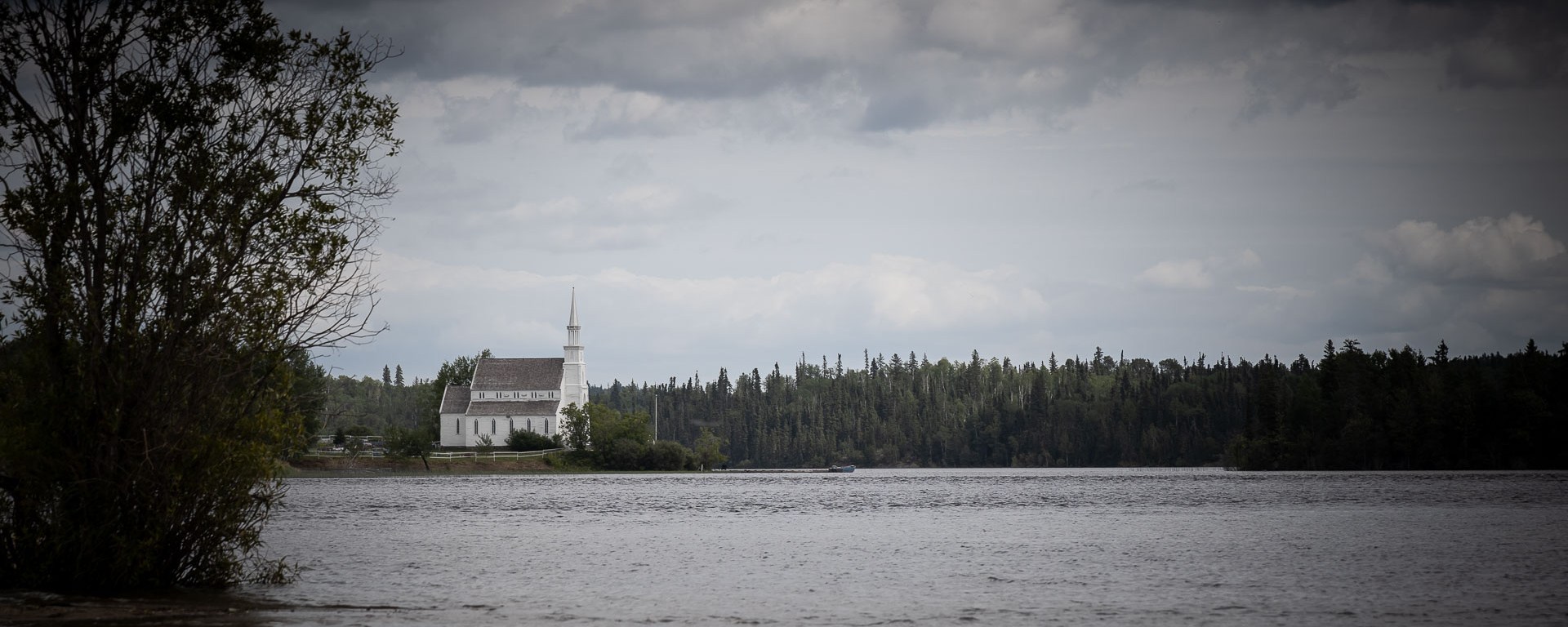 An old church stands before a coming storm.