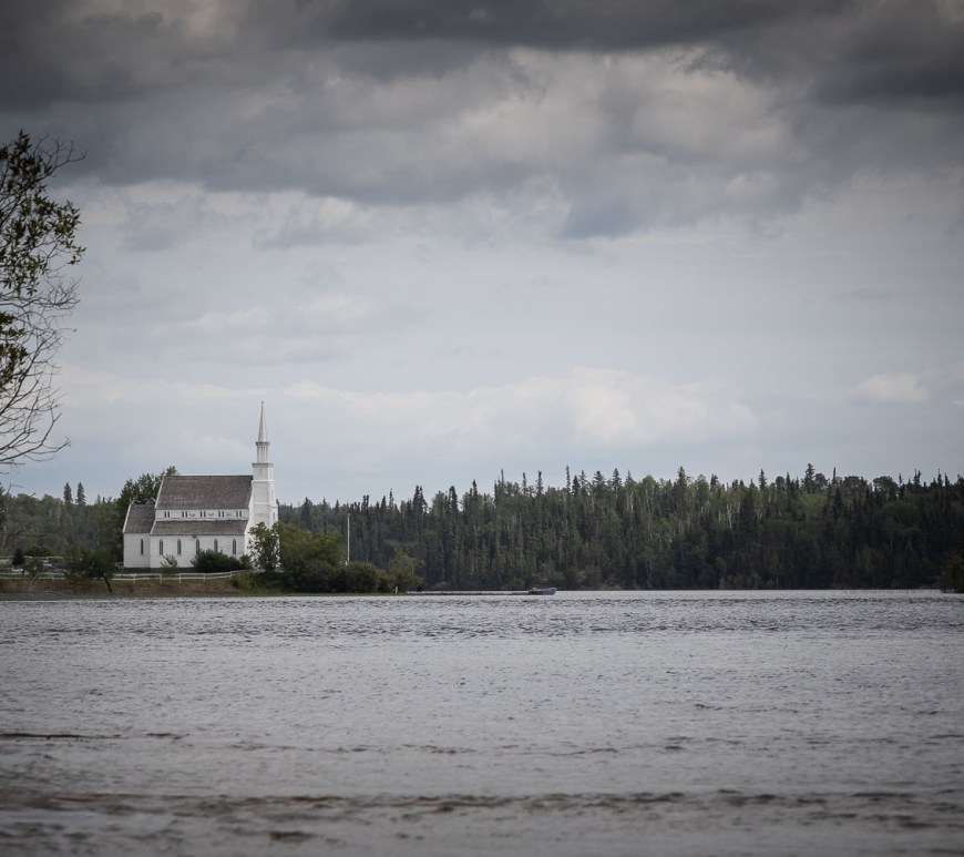 An old church stands before a coming storm.