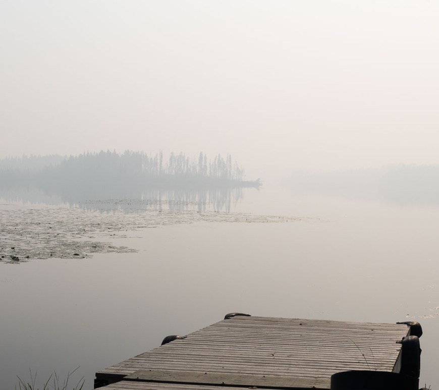 A thick fog covers the lake.