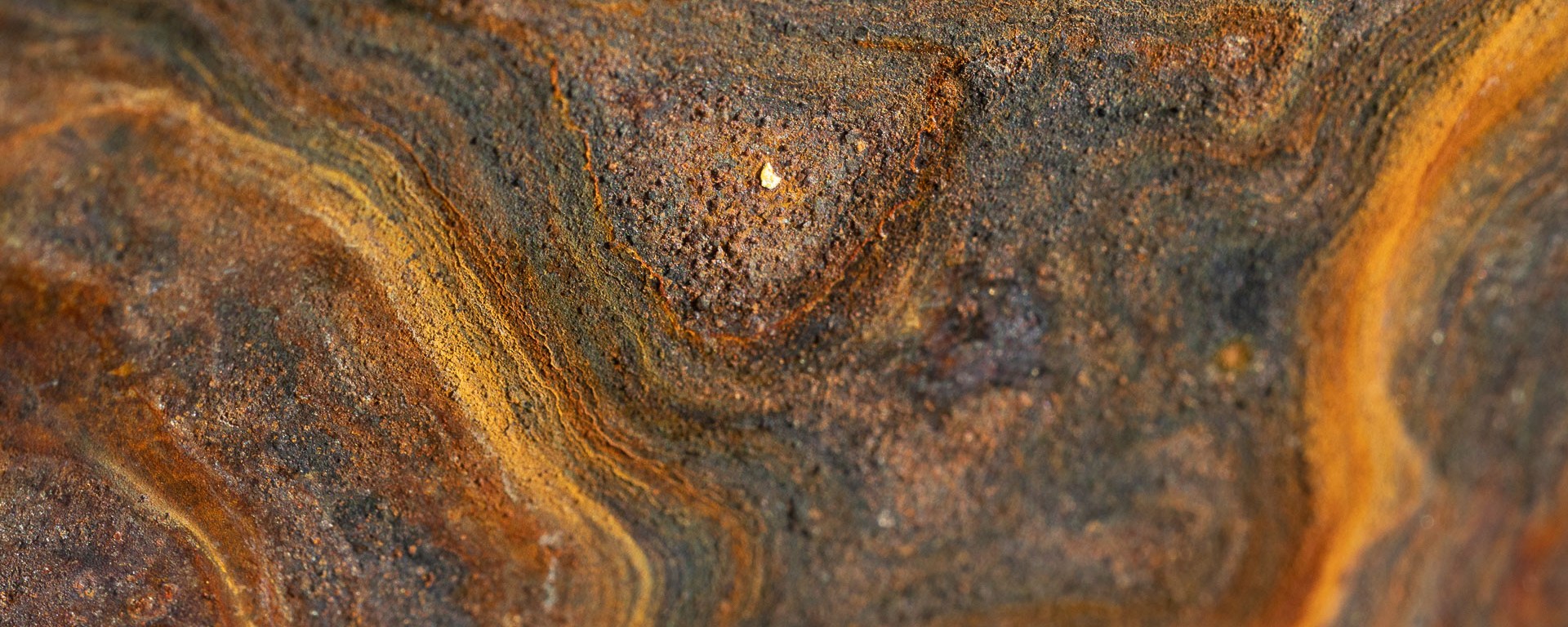 Swirls of rust slowly eat steel.