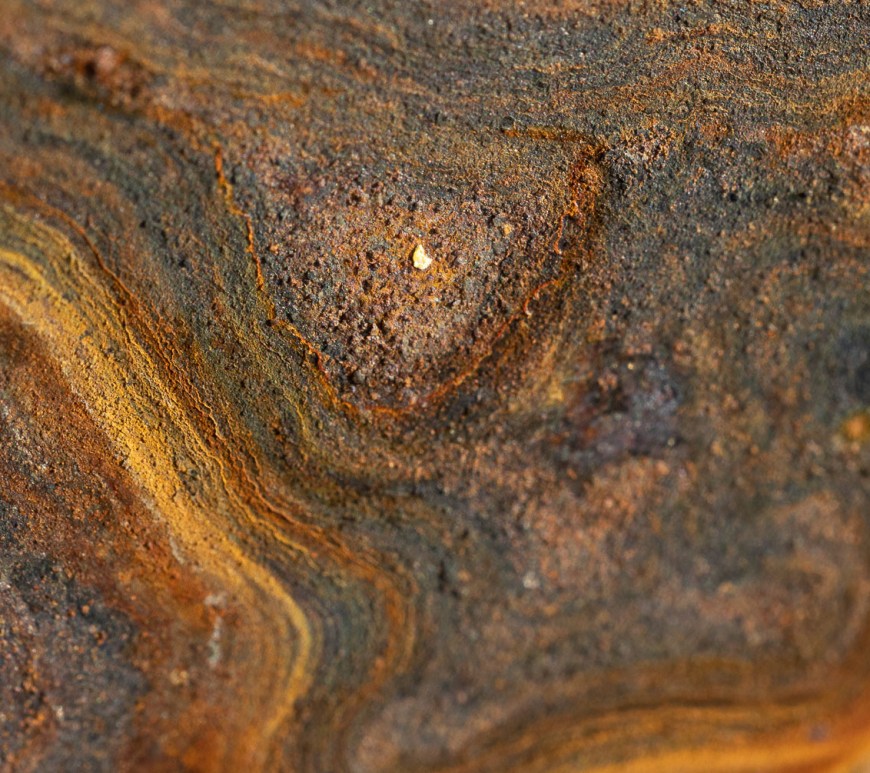 Swirls of rust slowly eat steel.
